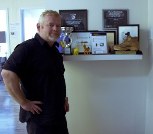 Steven at the Bluink office, showcasing their accomplishments