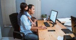 Dad working at home with his kids.