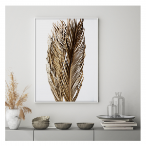 A displayed framed printed image of dried flowers. 