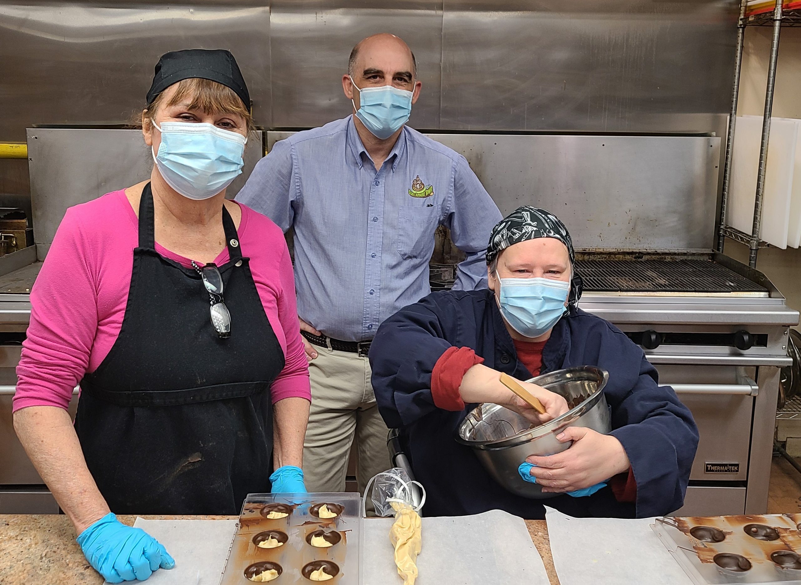 A picture of Ed Hemphill - owner of Bean Around Town with Pierrette Vezina - Head Chocolatier of Wabano Fine Chocolates and volunteer chocolatier Valerie Edwards