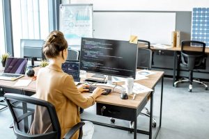 Woman working on code at her desk