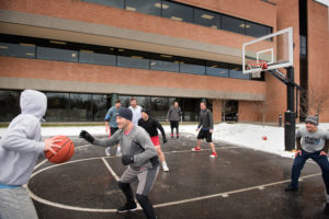 VIP staff play basketball at the outdoors basketball court in Vermont