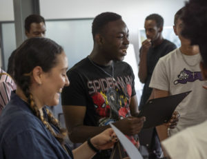 A student from the 2022 cohort of the Summer Company program receives his diploma at a graduation ceremony at Invest Ottawa