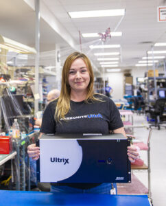 A Ross Video team member holds a box containing the company's Ultrix solution. 