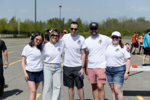 Photo of team members from Solink - standing side by side at a casual company event. 