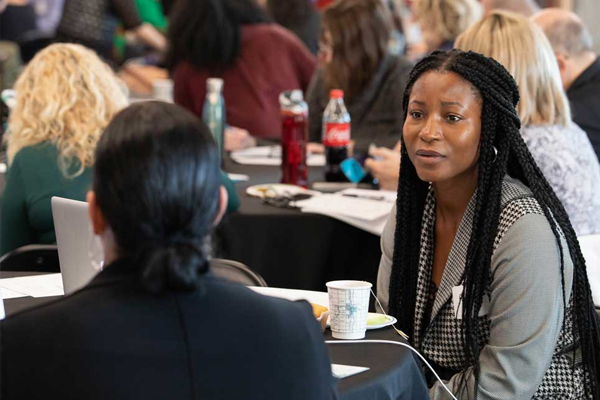 Person listening to a conversation during a networking event
