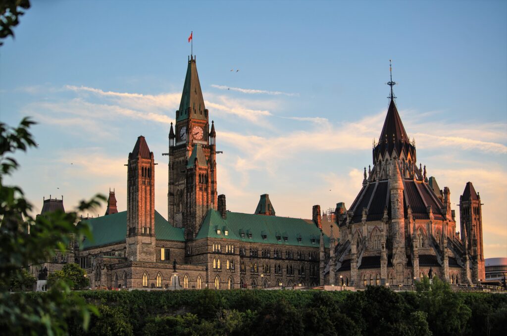 An image of the Ottawa skyline at dusk, overlooking the Pariliament buildings and the National Arts Centre