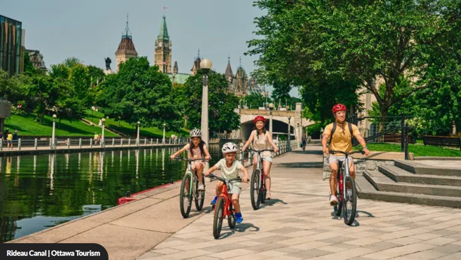 An image of the Ottawa skyline at dusk, overlooking the Pariliament buildings and the National Arts Centre