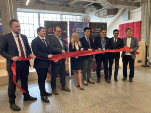 A photo of a ribbon cutting event at Bayview Yards in Ottawa celebrating the opening of a new office.