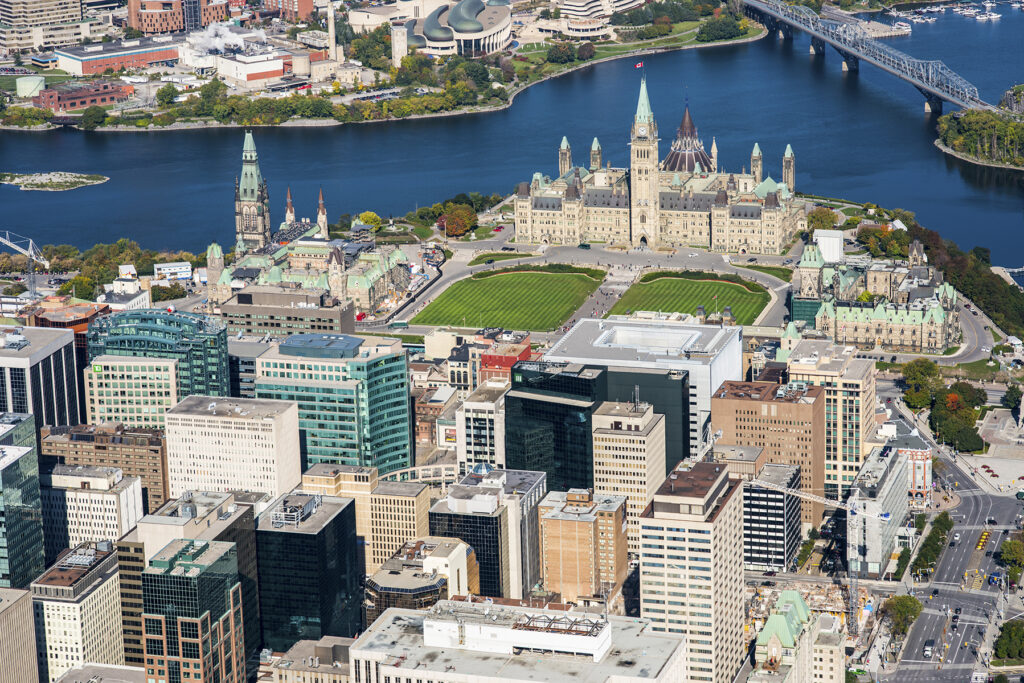 An image of the Ottawa skyline at dusk, overlooking the Pariliament buildings and the National Arts Centre