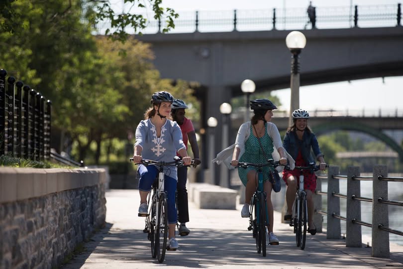 An image of the Ottawa skyline at dusk, overlooking the Pariliament buildings and the National Arts Centre
