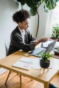 A woman during a video call on her laptop - working from her home office. 