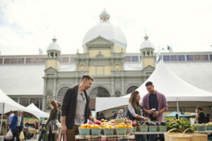 People browse through fresh produce at an outdoor farmers market in downtown Ottawa.