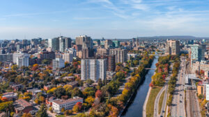 Stunning Aerial View of Downtown Ottawa, Ontario, Canada, with the Rideau Canal Lined with Vibrant Autumn Foliage, Gatineau Hills behind, Capturing the Beauty of Fall in the Capital