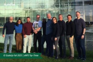 The team for SureWx stands and poses for a photo together.