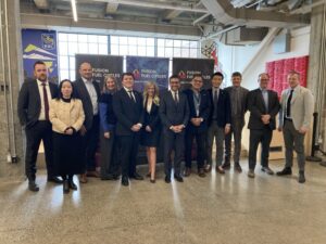 Team members of Fusion Fuel Cycles posing for a photo with Invest Ottawa team members at Bayview Yards in Ottawa for a ribbon cutting event in December, 2025