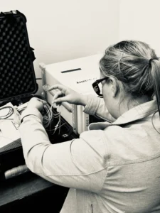 A person works with electronic components. 