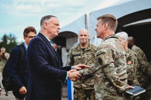  Honourable David J. McGuinty, Minister of National Defence shakes the hand of military personnel at the Red Cobalt event. 